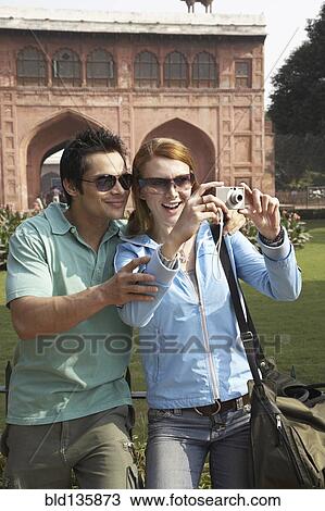 Couple taking pictures at Red Fort, Delhi, India View Large Photo Image Stock Image - Couple taking pictures at Red Fort, Delhi, India. Fotosearch