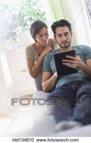 Couple using digital tablet together View Large Photo Image Stock Image - Couple using digital tablet together. Fotosearch