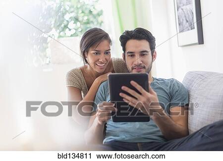 Stock Image - Couple using digital tablet together. Fotosearch