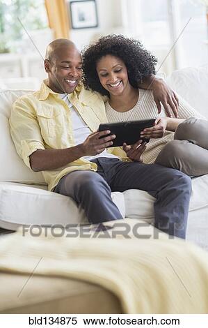 Stock Photography - Couple using digital tablet together. Fotosearch