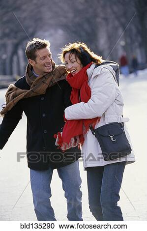 Couple walking in urban park View Large Photo Image Stock Image - Couple walking in urban park. Fotosearch