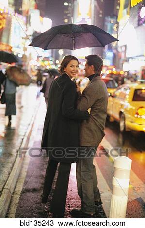 Couple walking on city street at night, New York City, New York, United States View Large Photo Image Stock Image - Couple walking on city street at night, New York City, New York, United States. Fotosearch