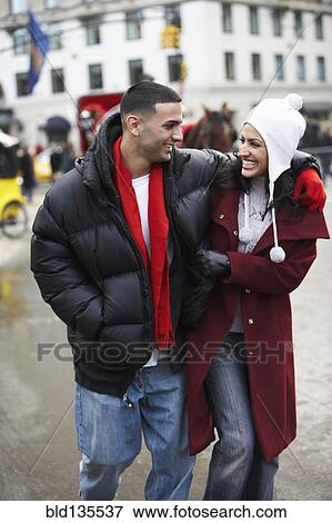 Stock Photo - Couple walking together on city street. Fotosearch
