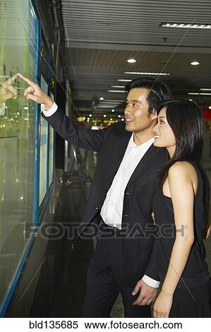 Couple window shopping on city street View Large Photo Image Stock Photography - Couple window shopping on city street. Fotosearch