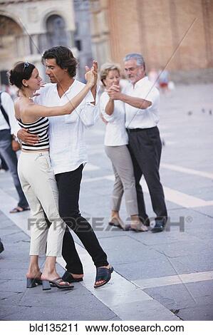 Couples dancing in town square View Large Photo Image Stock Image - Couples dancing in town square. Fotosearch