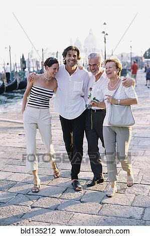 Couples walking together on city street View Large Photo Image Stock Image - Couples walking together on city street. Fotosearch