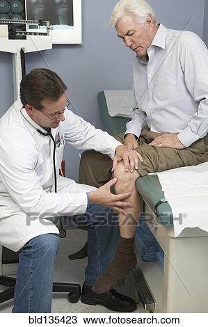 Doctor examining Senior man's knee View Large Photo Image Stock Image - Doctor examining Senior man's knee. Fotosearch