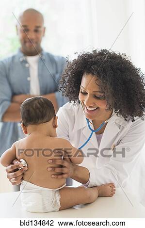 Doctor giving baby a check up in office View Large Photo Image Stock Image - Doctor giving baby a check up in office. Fotosearch