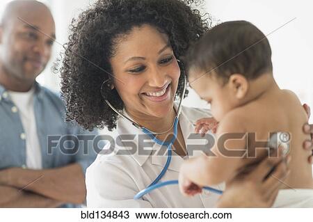 Doctor giving baby a check up in office View Large Photo Image Stock Image - Doctor giving baby a check up in office. Fotosearch