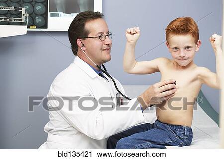 Doctor listening to boy's heartbeat in office View Large Photo Image Stock Image - Doctor listening to boy's heartbeat in office. Fotosearch