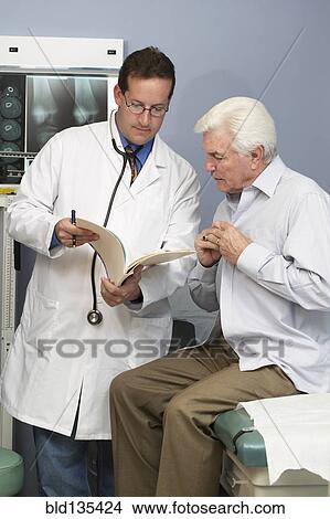 Doctor talking to patient in hospital room View Large Photo Image Picture - Doctor talking to patient in hospital room. Fotosearch