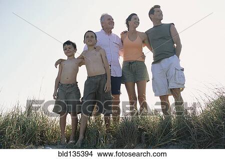 Family overlooking beach from hilltop View Large Photo Image Picture - Family overlooking beach from hilltop. Fotosearch