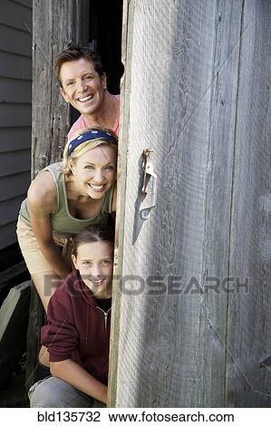 Family peeking out from behind door View Large Photo Image Stock Image - Family peeking out from behind door. Fotosearch