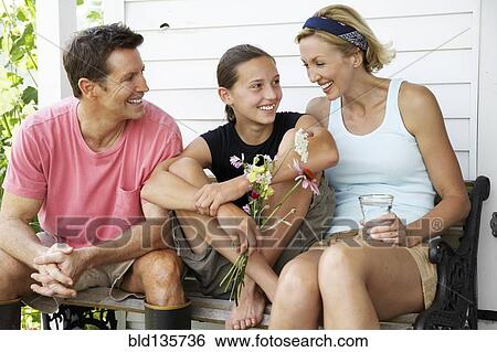 Family relaxing together outdoors View Large Photo Image Stock Photograph - Family relaxing together outdoors. Fotosearch