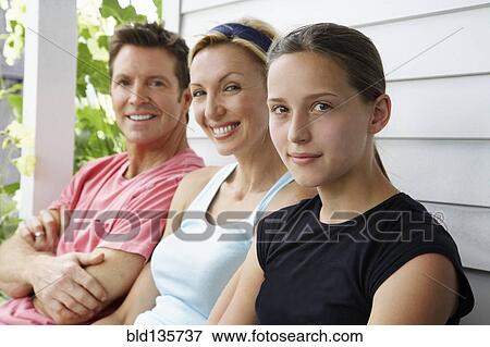 Family sitting together outdoors View Large Photo Image Stock Photo - Family sitting together outdoors. Fotosearch