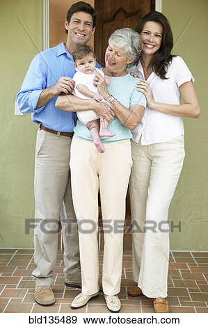 Family smiling together at front door View Large Photo Image Stock Photo - Family smiling together at front door. Fotosearch