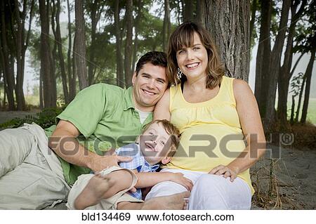 Family smiling together in forest View Large Photo Image Stock Photo - Family smiling together in forest. Fotosearch