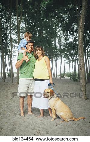 Family smiling together on wooded beach View Large Photo Image Picture - Family smiling together on wooded beach. Fotosearch