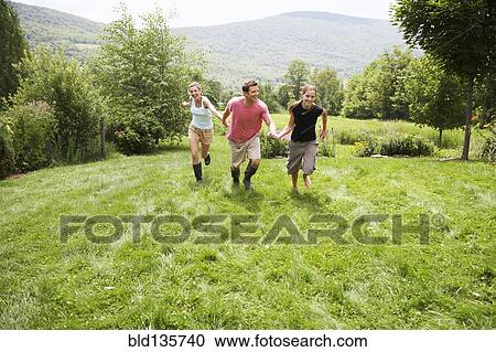 Family walking together in backyard View Large Photo Image Stock Image - Family walking together in backyard. Fotosearch