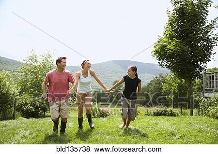 Family walking together in backyard View Large Photo Image Stock Photo - Family walking together in backyard. Fotosearch