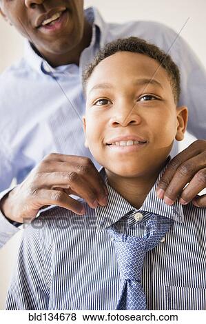 Father adjusting son's tie View Large Photo Image Stock Photo - Father adjusting son's tie. Fotosearch