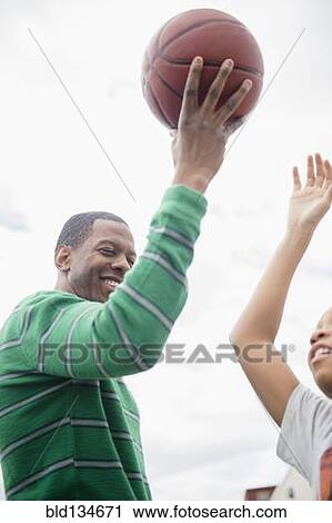 Father and son playing basketball outdoors View Large Photo Image Stock Image - Father and son playing basketball outdoors. Fotosearch