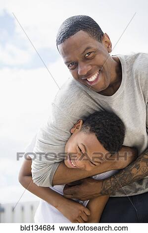 Picture - Father and son playing outdoors. Fotosearch