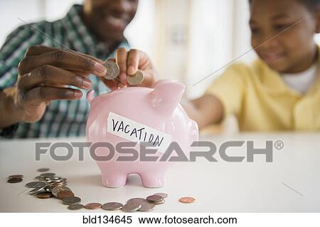 Stock Photography - Father and son saving coins for vacation. Fotosearch