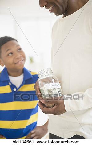 Father and son saving money for college View Large Photo Image Stock Image - Father and son saving money for college. Fotosearch