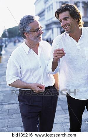 Stock Photograph - Father and son walking on city street. Fotosearch