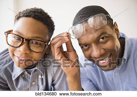 Father and son wearing glasses together View Large Photo Image Stock Image - Father and son wearing glasses together. Fotosearch