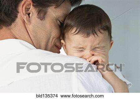Father comforting crying baby View Large Photo Image Picture - Father comforting crying baby. Fotosearch