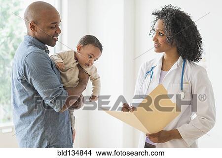 Father with baby talking to doctor View Large Photo Image Picture - Father with baby talking to doctor. Fotosearch