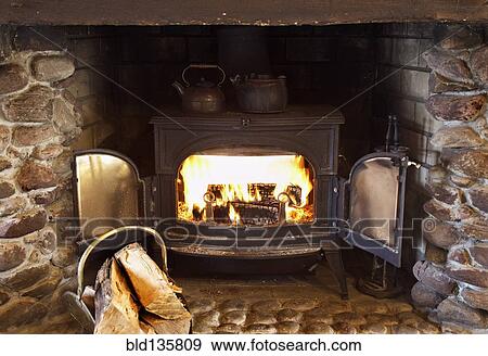 Fire burning in wood stove View Large Photo Image Stock Photo - Fire burning in wood stove. Fotosearch