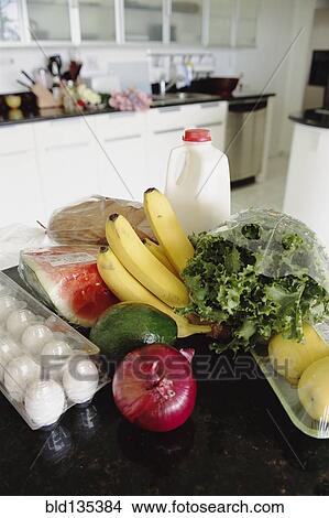 Fresh produce, milk and eggs on kitchen table View Large Photo Image Picture - Fresh produce, milk and eggs on kitchen table. Fotosearch