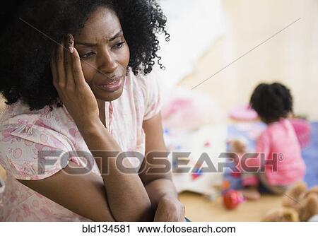 Frustrated mother rubbing her temples View Large Photo Image Stock Image - Frustrated mother rubbing her temples. Fotosearch