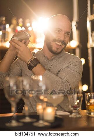 Hispanic bartender making drinks at bar View Large Photo Image Stock Image - Hispanic bartender making drinks at bar. Fotosearch