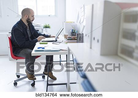 Hispanic businessman working at desk View Large Photo Image Picture - Hispanic businessman working at desk. Fotosearch