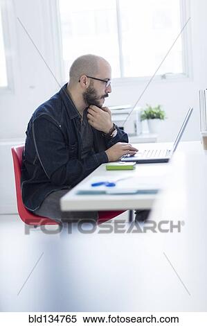 Hispanic businessman working at desk View Large Photo Image Stock Photography - Hispanic businessman working at desk. Fotosearch