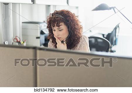Stock Image - Hispanic businesswoman working in office. Fotosearch