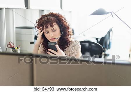 Stock Image - Hispanic businesswoman working in office. Fotosearch