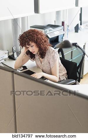 Stock Photo - Hispanic businesswoman working in office. Fotosearch