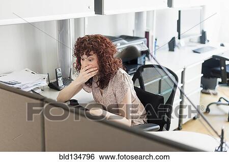 Stock Photograph - Hispanic businesswoman working in office. Fotosearch