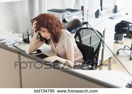 Stock Photography - Hispanic businesswoman working in office. Fotosearch