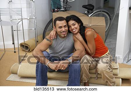 Hispanic couple smiling in new home View Large Photo Image Stock Image - Hispanic couple smiling in new home. Fotosearch