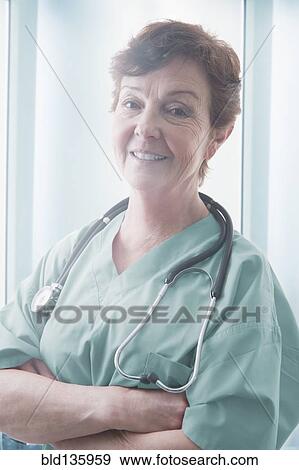 Stock Photo - Hispanic doctor smiling in hospital. Fotosearch