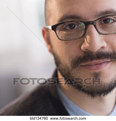 Stock Image - Hispanic man smiling in eyeglasses. Fotosearch