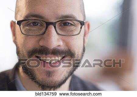 Hispanic man smiling in eyeglasses View Large Photo Image Stock Photo - Hispanic man smiling in eyeglasses. Fotosearch