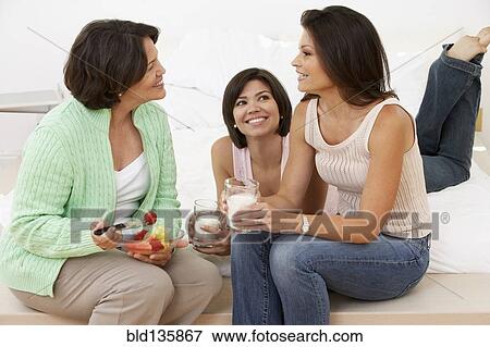 Hispanic mother and daughters relaxing together View Large Photo Image Stock Photo - Hispanic mother and daughters relaxing together. Fotosearch