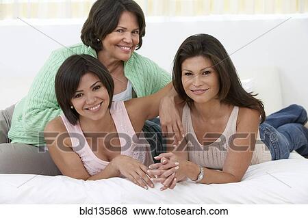 Hispanic mother and daughters relaxing together View Large Photo Image Stock Photo - Hispanic mother and daughters relaxing together. Fotosearch